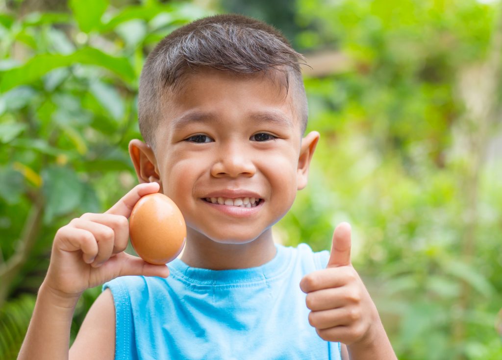 Child holding an egg